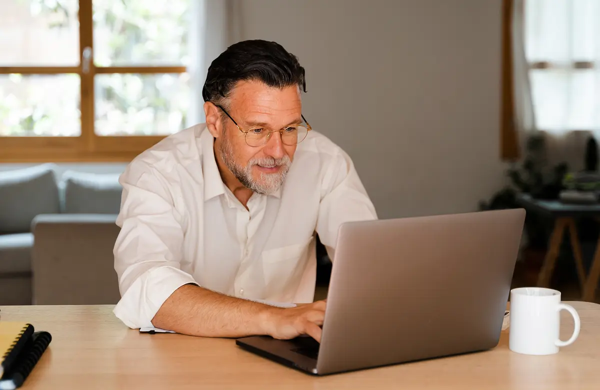 A person working on a laptop manages AI applications and data protection